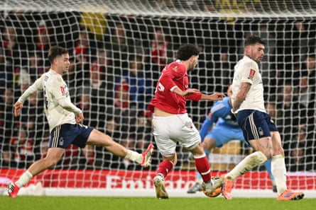 Wrexham’s New Zealand defender Liberato Cacace opens the scoring with help from a small deflection.