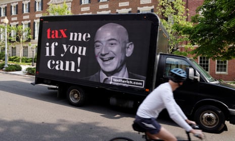 A video protest sign on a truck paid for by the Patriotic Millionaires drives past a mansion owned by the Amazon founder, Jeff Bezos, in Washington last month.
