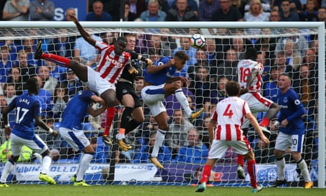The Everton goalkeeper Jordan Pickford punches the ball clear against Stoke City