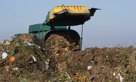 A truck unloads organic waste to be used for composting at a facility in Woodland, California.