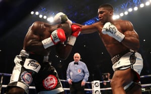 Anthony Joshua goes on the offensive as Carlos Takam covers up.