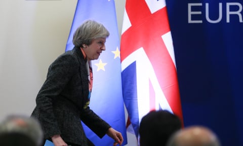 Theresa May leaves the podium after a press briefing during the European spring summit in Brussels.
