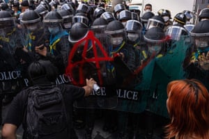 Protesters spray paint on riot police during a demonstration near the Asia-Pacific Economic Cooperation summit in Bangko