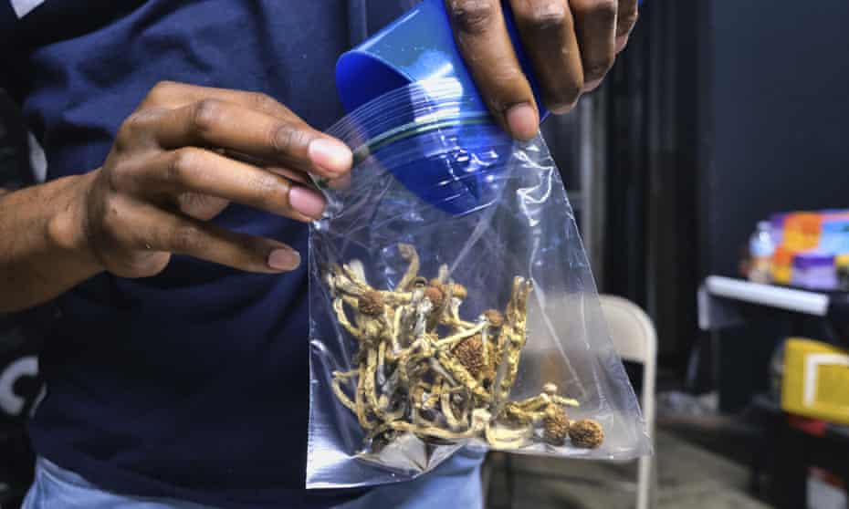 A vendor packages psilocybin mushrooms at a cannabis market in Los Angeles. 