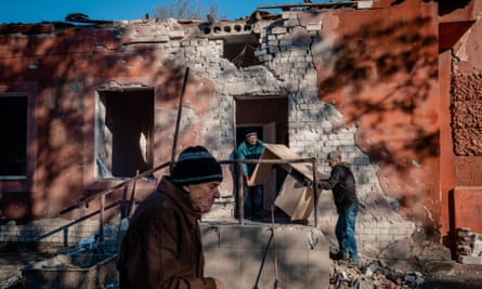 Men carry furniture from the hospital maternity unit damaged after Russian shelling in Kherson, 28 December 2022.