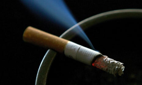 A cigarette burning on an ashtray. 