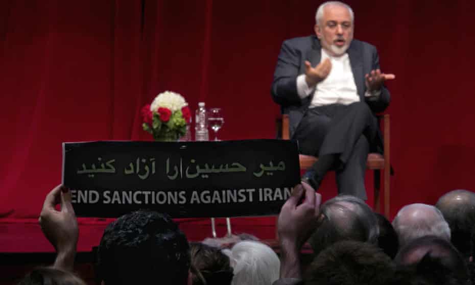 A sign during an interview with Iran’s foreign minister in New York carries one message in Persian and another in English. “Release [opposition leader] Mir Hossein Mousavi,” it reads in Persian. 