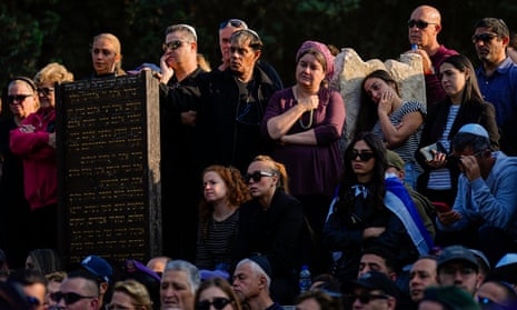 Mourners gather around the grave of Israeli soldier Captain Harel Ittah during his funeral in Netanya, Israel, Sunday, 31 December.
