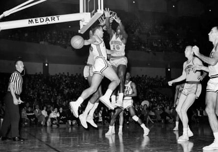The St Louis Hawks’ Cliff Hagan (16) looks to pass as the San Francisco Warriors’ Al Attles (16) defends during a 1963 game.