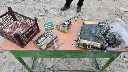 Charred pieces of metal and plastic on a table