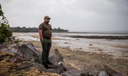 Andriy Seletskyi, the mayor of Novovorontsovka military administration, looks out at the partially drained Dnipro River.