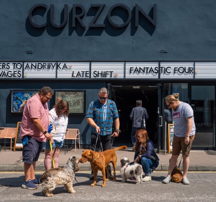 Dogs with their owners outside the Curzon cinema in Canterbury, UK