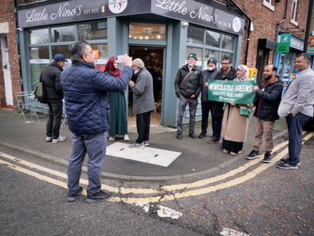 Supporters with Green party candidate Mohammed Suleman outside a cafe