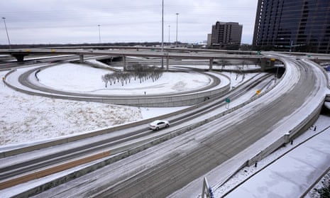 A lone driver makes their way through icy road conditions at the LBJ 635 Freeway and North Dallas Tollway interchange on Tuesday.