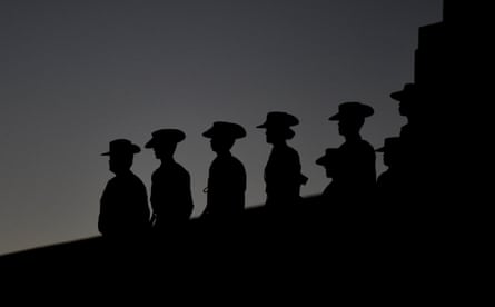 Members of the defence force stand silhouetted during the Dawn service at the Shrine of Remembrance for Anzac Day