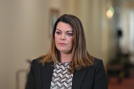 A woman with dark hair and a dark blazer.