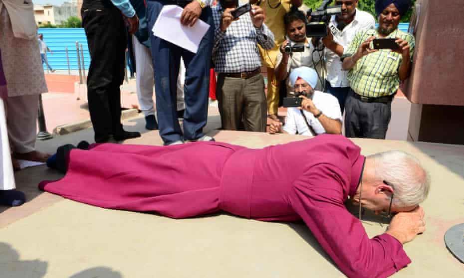 The archbishop of Canterbury, Justin Welby, prostrates himself in tribute to the victims of the Amritsar massacre