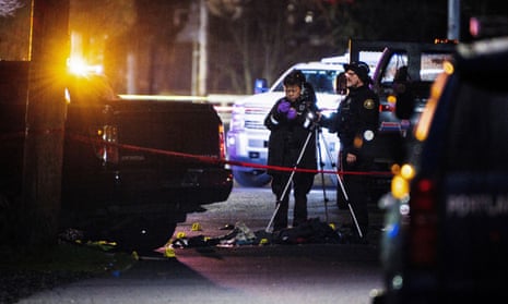 Police officers view a crime scene where one person was shot dead in Portland.