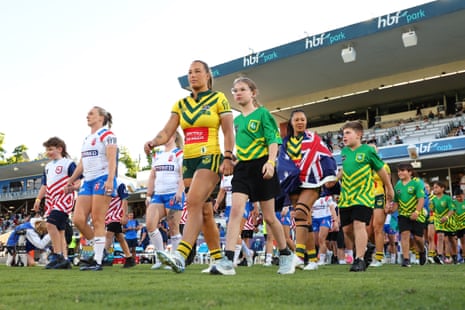 Jodie Cunningham of England and Isabelle Kelly of Australia lead the teams out at HBF Park