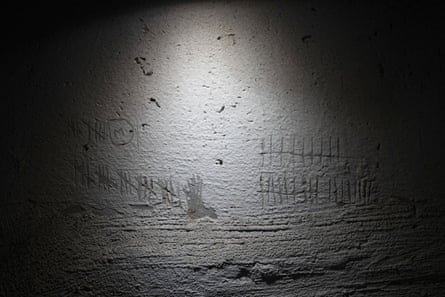 Digits used to keep track of time, scratched by detainees on the wall of a basement in a building used, according to a war crimes prosecutor, by Russian forces as a place of torture in Kherson, 8 December.