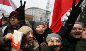 A man holds a copy of the Polish constitution at an anti-government protest in December.
