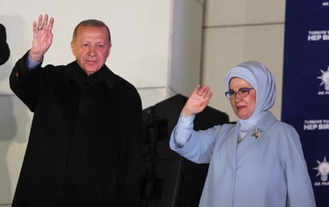 Turkish President Recep Tayyip Erdoğan, accompanied by his wife Ermine Erdoğan, greets supporters at the AK party headquarters in Ankara in the early hours of Monday.