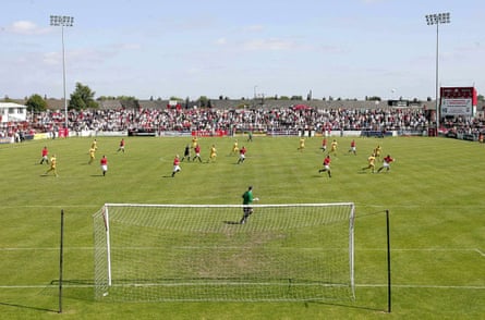 FC United of Manchester (in red) in action during their inaugural match, a friendly against Leigh RMI at Hilton Park in July 2005