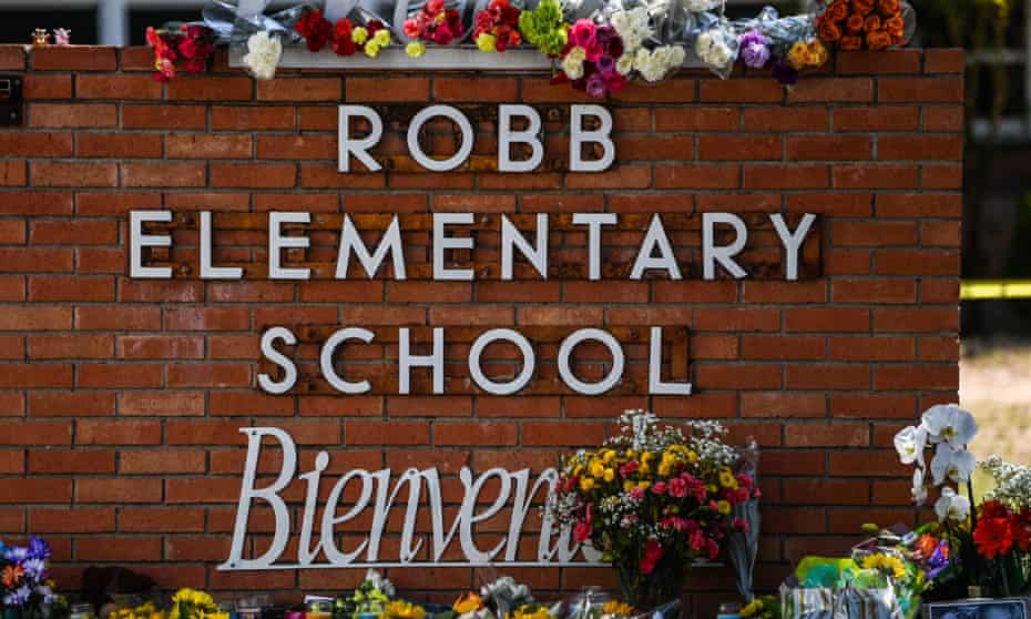 Flowers are placed on a makeshift memorial in front of Robb elementary school in Uvalde, Texas.