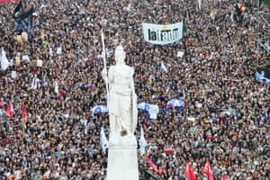 Aerial view of a huge crowd, some holding flags and placards
