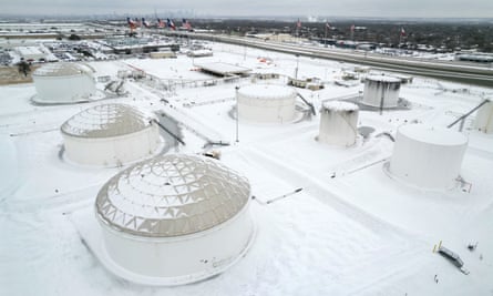 Fuel tanks sit covered in snow and ice at an Exxon Mobile Pipeline facility in Texas.