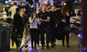 People are evacuated following an attack at the Bataclan concert venue in Paris.