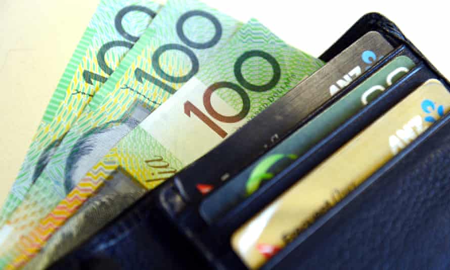 $100 Australian dollar notes pop out of a wallet with credit cards, pictured in Brisbane, Aug. 20, 2013.