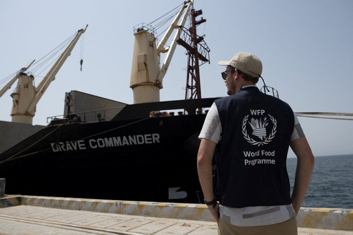 UN food relief official looks at ship at dock