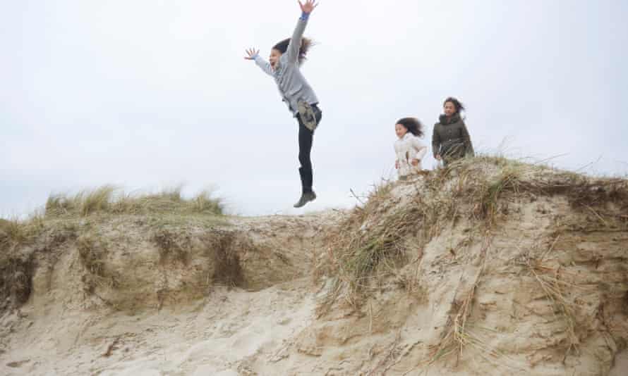 Children playing on the sand dunes at Studland Bay, Dorset.