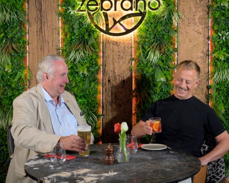 Robin and Aslak laughing at a restaurant table