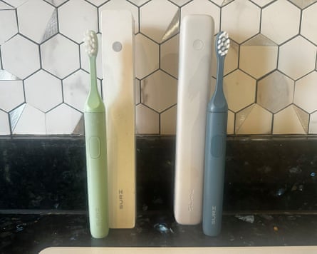 Suri 1.0 and Suri 2 toothbrushes on a bathroom worktop