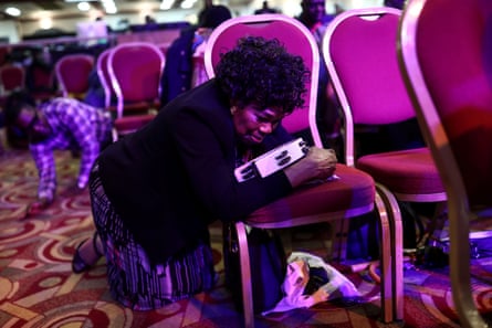 A worshipper kneels to pray during a Sunday service at the House of Praise church in Camberwell, south London