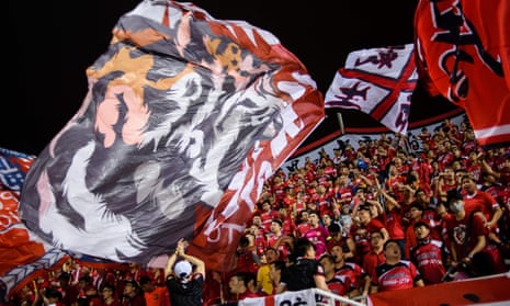 Fans of China’s Guangzhou Evergrande wave large flags during the AFC Champions League against Hong Kong’s Eastern at Mongkok Stadium
