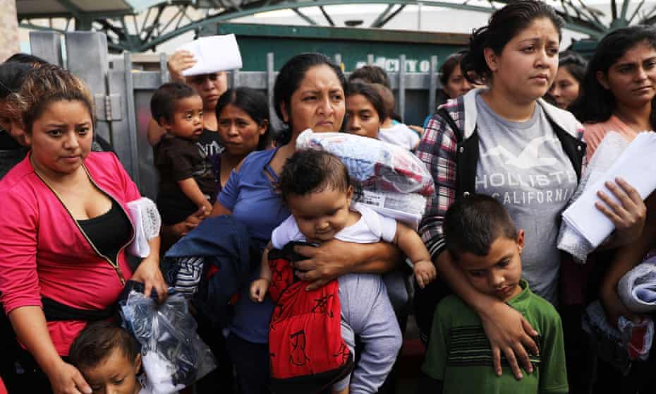 Women and children, many fleeing poverty and violence in Central America, arrive at a bus station following release from Customs and Border Protection on 22 June 2018 in McAllen, Texas. 