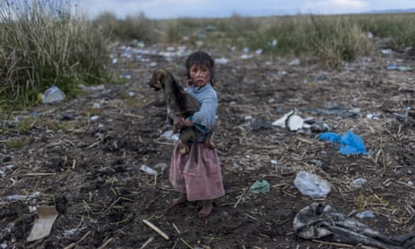 A child walks on the trash strewn shore of Lake Titicaca