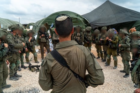 A handout photo issued by Israel’s military showing soldiers getting ready for deployment inside Lebanon.