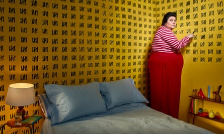 Photograph of Sofie Hagen in a bedroom with lots of marks counting days on the walls