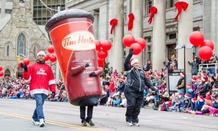 A large cup of Tim Hortons coffee marches in the Santa Claus parade in Toronto, Ontario.