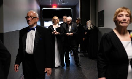 Nancy McGuire (in the rear left) walks with other singers from The Towne Singers to their break room after the first half of a fundraising concert the group does each year to help pay for their activities.