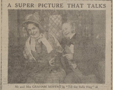 A sepia-toned newspaper advertisement featuring an image of a smiling man and a woman dressed in Victorian costumes. It reads at the top: ‘A SUPER PICTURE THAT TALKS’. Below the photo it reads: ‘Mr and Mrs GRAHAM MOFFAT in ‘Tills the Bells Ring’ at’