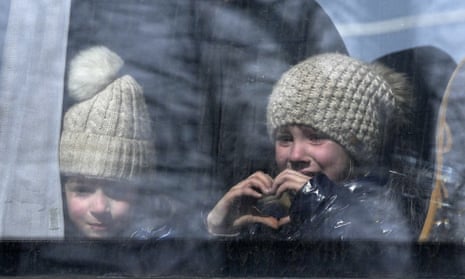 A  girl makes a heart shape as civilians are apparently evacuated from Mariupol under the control of Russian military and pro-Russian separatists.