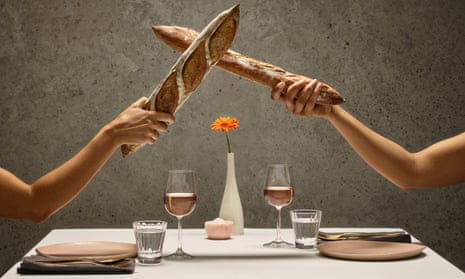 Picture of two people having a meal but fencing with baguettes