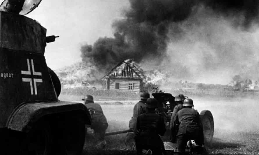 Armoured car and anti-tank gun in action on the edge of a town during the German attack on the Soviet Union, June 1941.