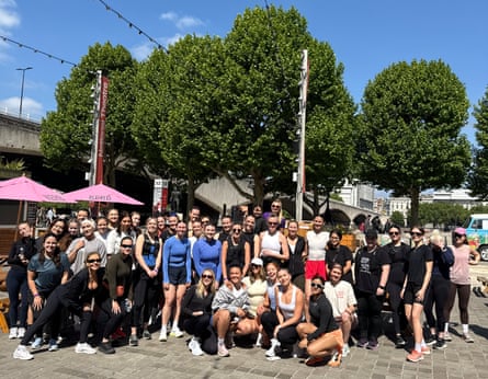 Cliq run club members pose for a photo outside on a sunny day