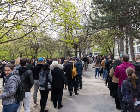 People queue outside a polling station to cast their ballots in Budapest, Hungary.